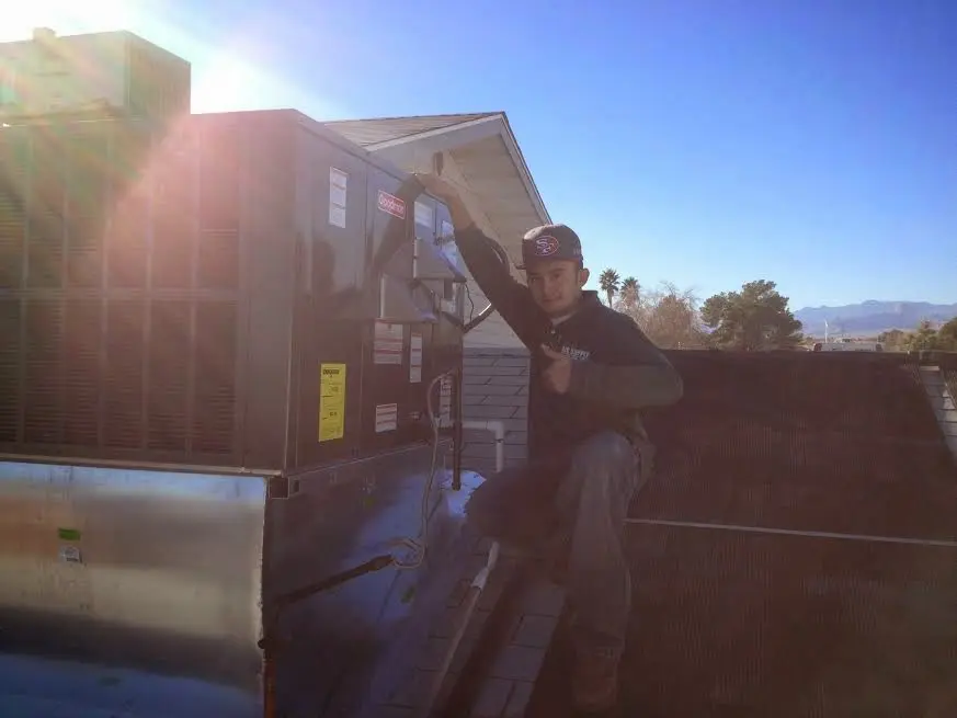 HVAC technician performing Heat Pump Repair on a rooftop unit in Severn